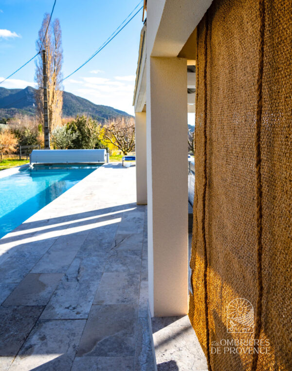 Coconut fiber roll-up shade for swimming pools